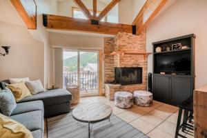 a living room with a couch and a fireplace at Lift West #215 in Red River