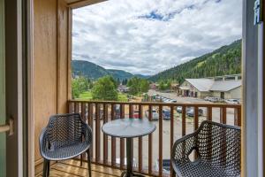a balcony with a table and chairs and a view of a town at Lift West #215 in Red River
