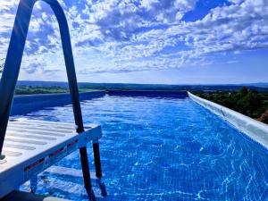 a swimming pool with a view of the water at Odmaralište Islovo Brdo in Prnjavor