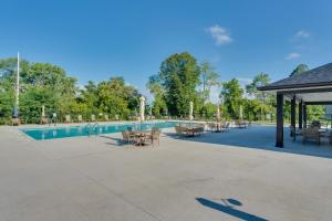 a swimming pool with tables and chairs and a pavilion at Elegant 4-Season Lake Geneva Condo with Fireplace! in Lake Geneva