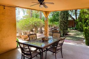a patio table with chairs and a ceiling fan at Renee Retreat in Phoenix