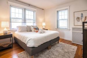 a bedroom with a large bed with two windows at Hyde Park Comfort with Office Near Everything in Cincinnati +22 photos