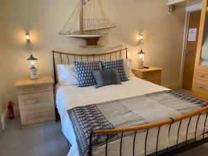 1 dormitorio con 1 cama con un barco en la pared en Apartment 24 en Salcombe