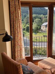 a living room with a couch and a large window at Sallent de Gállego - Formigal - Pirineos Sur in Sallent de Gállego