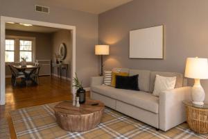 a living room with a couch and a table at Spacious in Hyde Park with Patio in Cincinnati