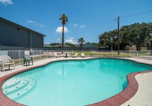 a large swimming pool with blue water at Econo Lodge Inn & Suites Fulton - Rockport in Rockport