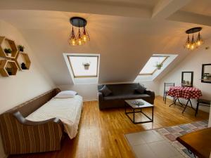 a living room with a bed and a couch at KENT Apartments in Pristina