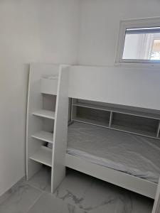 a white bunk bed in a room with a window at Appartement 2 chambres in Cavalaire-sur-Mer