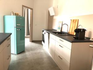a kitchen with a green refrigerator and a sink at Atelier Loft Bürgel in Bürgel