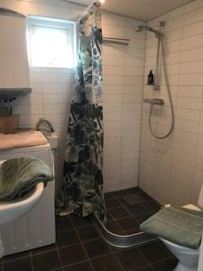 a bathroom with a shower and a sink at Boende nära havet in Varberg