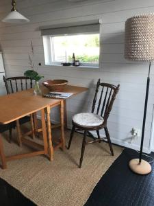 a dining room with a wooden table and chairs at Boende nära havet in Varberg