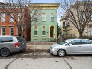 two cars parked in a parking lot in front of a house at Studio steps to Soccer and OTR and Downtown in Cincinnati