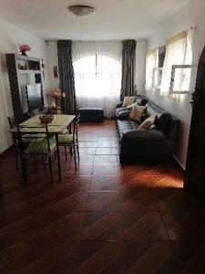 a living room with a couch and a table at SAN PAOLY. in Trujillo