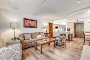 a living room with a couch and a table at Mountain Plaza Base Camp in Copper Mountain