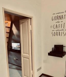 a room with a door with a sign on the wall at La Dolce Vita in Rome