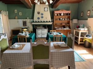 a living room with two tables and a kitchen at Fattoria Amelia in Santa Caterina