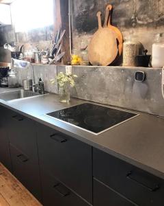 a kitchen with a sink and a counter top at Bo på Kvarnen in Varberg