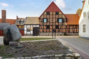 un viejo edificio con una estatua delante de él en Litet gathus mitt i Ystad, en Ystad