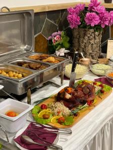 a buffet with a plate of food on a table at Chata Dolina v Bachledke in Ždiar