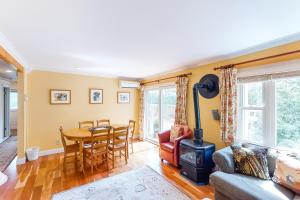 a living room with a table and a wood stove at Mountainside Resort F401 in Stowe