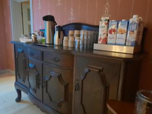 a wooden cabinet with food on top of it at Sjötorps Säteris 1600-tals Huvudbyggnad in Larv +21 photos