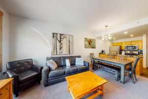 a living room with a couch and a table at Tucker Mountain Lodge 307 in Copper Mountain