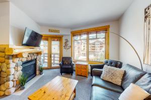 a living room with a couch and a fireplace at Tucker Mountain Lodge 307 in Copper Mountain