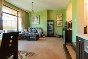 a living room with green walls and a couch at Luxury 2 bedroom villa in Sozopolis in Sozopol
