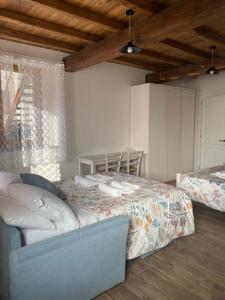 a bedroom with a bed and a couch in it at Agriturismo Il Mulino della Rocca in Berceto
