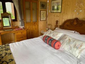 a bedroom with a white bed with a wooden headboard at Martha's retreat in Wimborne Minster