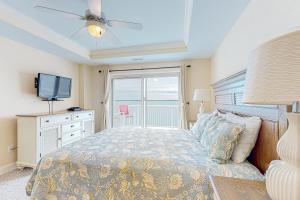 a bedroom with a bed with a television and a window at Seventh Heaven in Indian Beach +40 photos