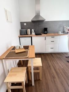 a kitchen with a table and chairs and a stove at Fishermans House in Almograve