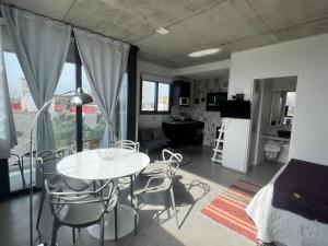 Remedios de EscaladaにあるHermoso Loft cerca de todoのテーブルと椅子、キッチンが備わる客室です。