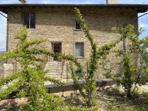 a brick building with trees in front of it at Foresteria Antica Bastia B&B in Bergamo