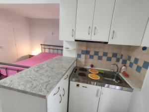 a small kitchen with a sink and a bed at Fanis & Polina -Mavrovouni beach in Mavrovouni