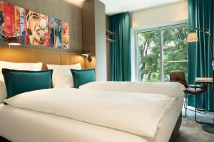 Katil atau katil-katil dalam bilik di Motel One Graz