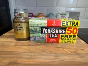 a counter with a jar of tea and a box of teazos at Daniel’s Semi Rural Retreat in Clowne