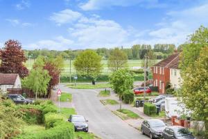 a street in a small town with cars parked at Private driveway - close to Warwick Racecourse & Warwick Castle!! in Warwick