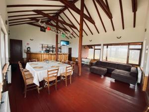 a dining room with a table and a couch at Cabana Chilii in Câmpulung