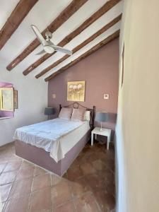 Ein Bett oder Betten in einem Zimmer der Unterkunft Cortijo Cuscurro
