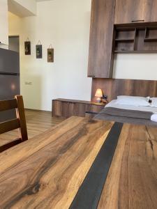 a bedroom with a bed and a wooden table at Tbilisi cozy apartment in Tbilisi City