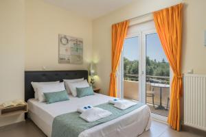 a bedroom with a bed with towels on it at AnnaBoutique Villa Beach, Heated Private Pool & BBQ in Kato Daratso +156 photos