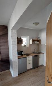 a kitchen with a sink and a stove top oven at Apartman Saric K&M in Baška Voda