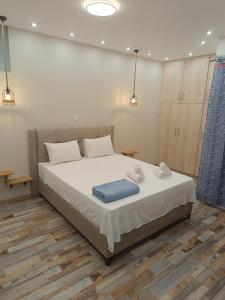 a bedroom with a bed with two towels on it at Athens Divine Apartment in Athens