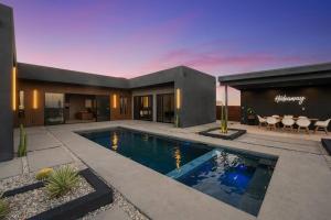 a house with a swimming pool in the yard at Black C House- Pool & Spa in Joshua Tree