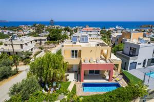 an aerial view of a house with a swimming pool at AnnaBoutique Villa Beach, Heated Private Pool & BBQ in Kato Daratso