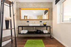 a bathroom with a sink and a mirror at Appartement Am Tatscherlehen in Piesendorf +22 photos