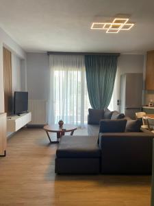 Kavala Luxury House في كافالا: غرفة معيشة مع أريكة وطاولة