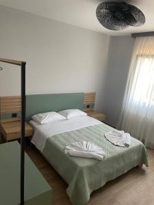 a bedroom with a bed with two towels on it at Kavala Luxury House in Kavála