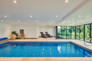 a swimming pool in a house with a living room at Big Barn 